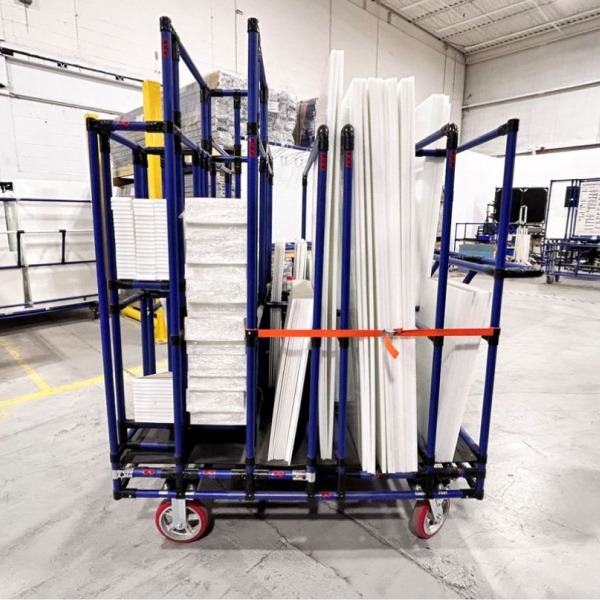 vertical kitting cart made of blue steel pipe and black joints. It has five separate locations for materials and panel boards.
