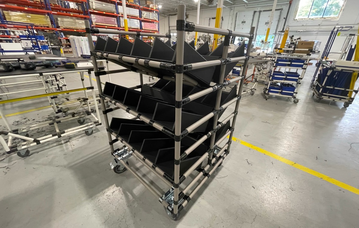 Three-level warehouse picking cart with five bin locations on each level and two sides to the cart with the same configuration. This picking cart has 30 separate bin placement locations, ensuring that warehouse employees only need to make one pass to complete 30 separate orders.