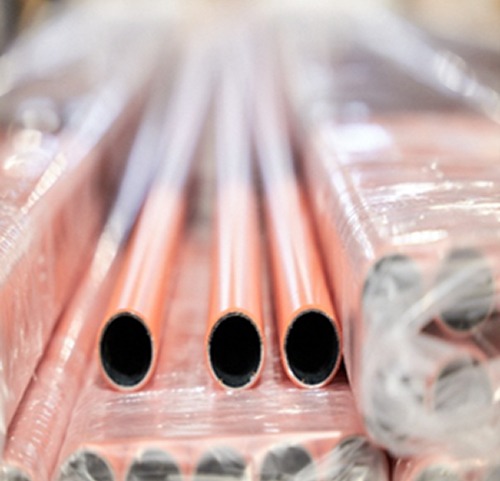 Close-up of Flexpipe’s orange polyethylene-coated galvanized steel pipes, prepared for storage or shipping.