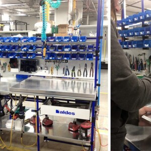 Workstation setup for electrical equipment manufacturing with a blue frame, stainless steel top, and tool board.