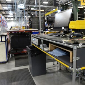 Modular workstation with built-in storage, tools, and computer equipment in an electrical equipment manufacturing facility