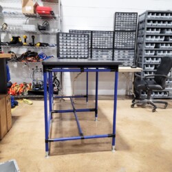 Integrated workstation and storage solutions with wire rack shelving and drawer cabinets for the electrical equipment industry