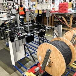 Modular workstation with reels and cable management tools for the electrical equipment industry, following 5S principles for organized industrial operations